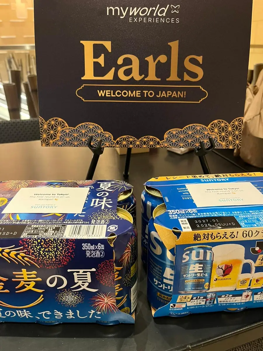 A welcome room drop: an Earls card saying Welcome to Japan, above a pack of Japanese beer