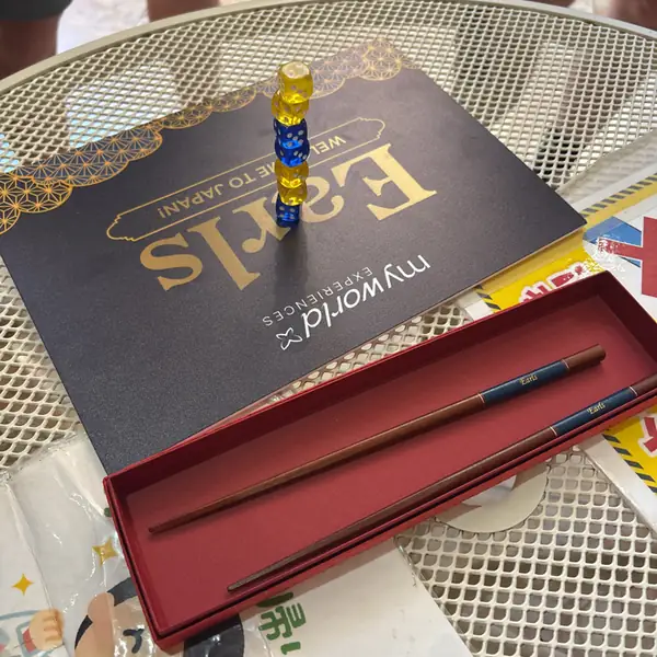 An Earls chopstick box on a café table, a tower of little blocks balanced beside it