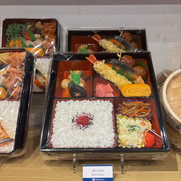 Plastic food in a shop window: a bento box, tempura and all