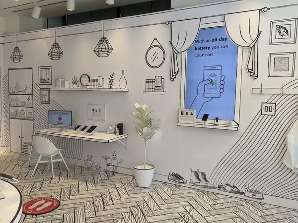 A hand-drawn style installation wall with phones on display