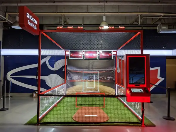 A baseball batting-cage activation inside an arena
